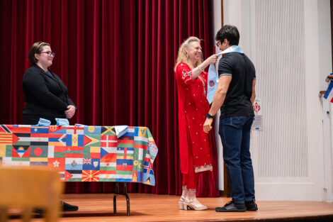 A student gets their stole at the international celebration.
