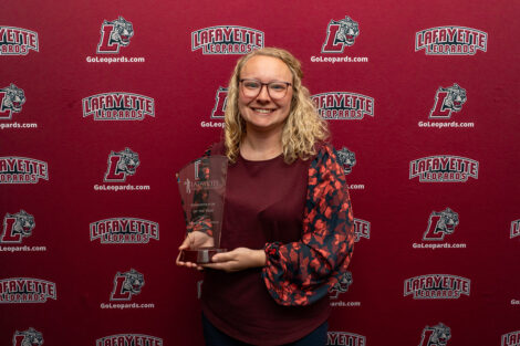 Melissa Dalrymple is holding a glass award.
