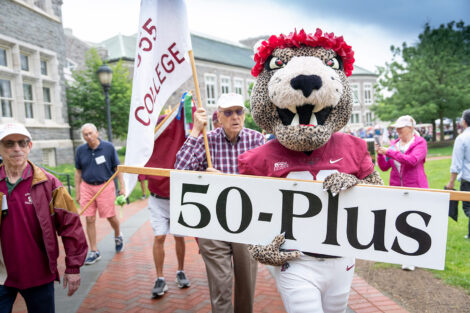 The Lafayette Leopard mascot holds a 50-plus sign.