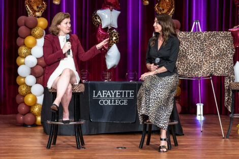 President Nicole Farmer Hurd is on a stage with President of the Alumni Association Fran Della Badia '91. They are having a conversation and both are holding microphones.
