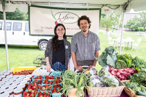 Samantha Comas and Josh Parr stand in the LaFarm tent at Reunion