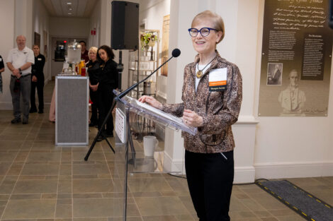 Trustee Laneta Dorflinger '75 stands at a podium and is smiling.