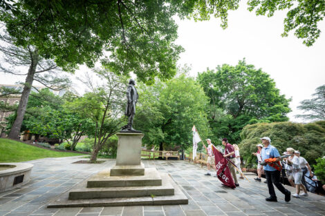 Members of the Class of 1975 climb the stairs near the statue of Marquis de Lafayette at Colton Chapel