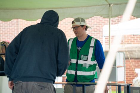 Conner Elliott-Knaggs talks with a customer at the West Ward Sale