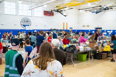 Volunteers and visitors walk through Paxinosa Elementary gymnasium during the West Ward Sale.