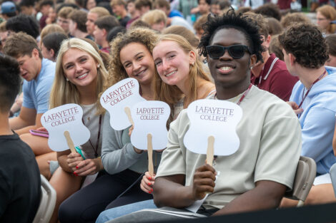 Students hold up Lafayette College fans during Convocation