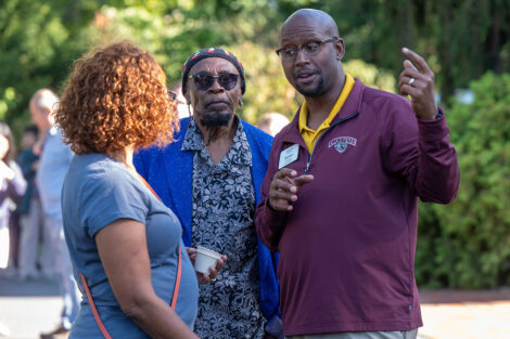 Families chat around a maroon table