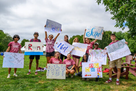Students hold up signs with their names on Lafayette College's Quad.