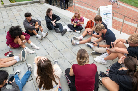 Students sit in a circle on the grass of Lafayette College's Quad.