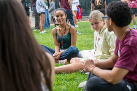 Students sit in a circle on the grass of Lafayette College's Quad.