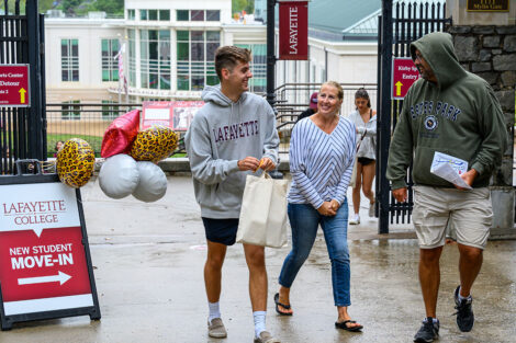 A family walks away from the new student move-in registration