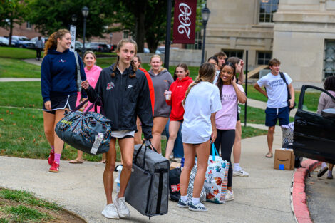 Students carry duffle backs into residence halls at Lafayette College.
