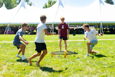 Students play lawn games in front of a tent on Lafayette College's Quad.