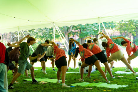 Students do yoga inside of a tent on Lafayette College's Quad