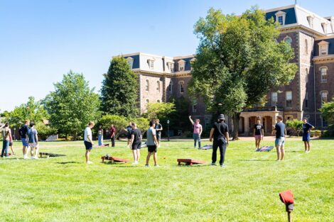 Students play lawn games in front of Pardee Hall.