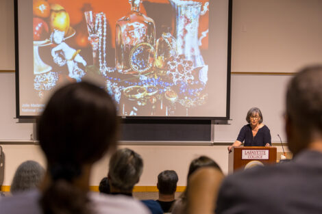 Elaine Stomber speaks at a podium.