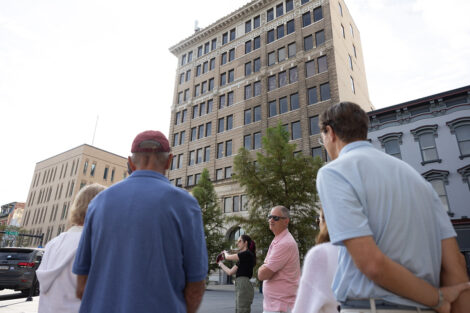 Tour guests look at the Alpha building