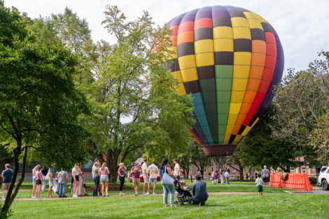 A hot air balloon on the Quad, surrounded by people.