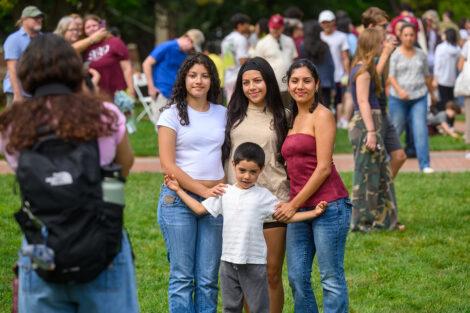 Families smile for a group photo.