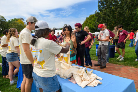 Students pick up their t-shirts at a long table on the Quad.