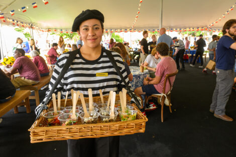 A catering member hands out salad.