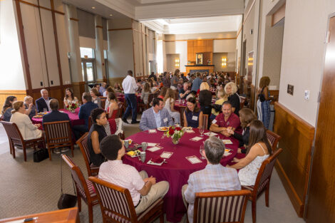 Alumni and their legacy students sit at tables and converse during the Legacy Brunch.