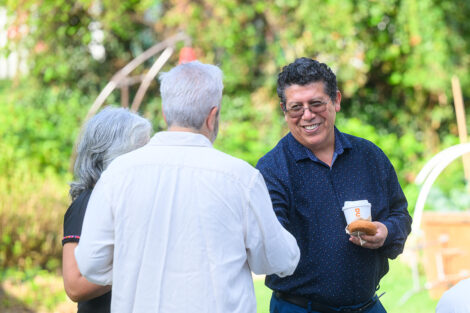 Two community members shake hands at McKelvy House.