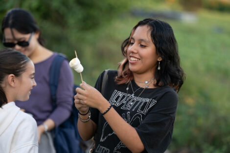An attendee holds up a marshmallow on a stick at LaFarm.