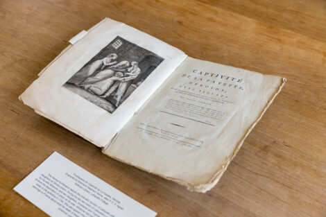 An artifact painting of Marquis de Lafayette ad his wife Adrienne in a book.