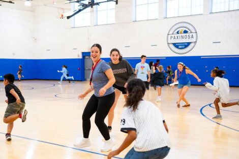 Lafayette POSP students running with Paxinosa Elementary School students in a gym