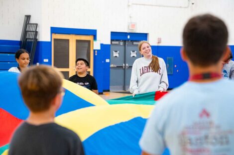Lafayette POSP students and Paxinosa Elementary School students playing with a parachute