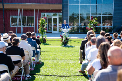 Andrew Wallach '95 speaks to the audience from a podium at the Wallach Center dedication.