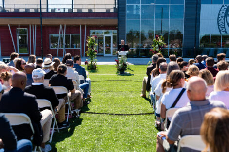 Chair of the Board of Trustees, Robert E. Sell '84 H'18 stands at a podium and speaks to the crowd.