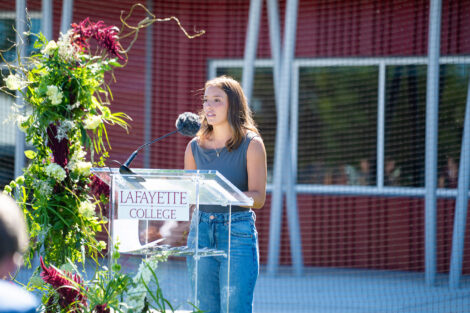 Women's lacrosse player Jordan Siemonsen '26 stands at a podium.