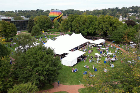An aerial photo of the tent in the middle of the Quad with the hot air balloon.