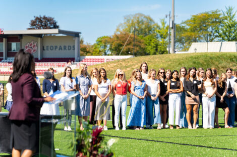 Members of the women's lacrosse team gather for the dedication.