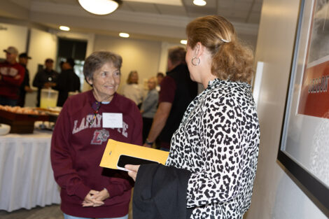 President Nicole Hurd speaks to an alum.