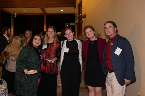 President Nicole Hurd and Bill Hurd smile with alumni.