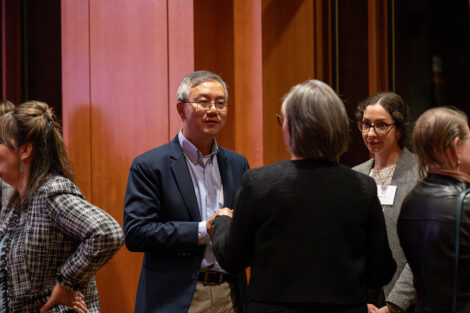 Guests talk to each other inside of the George Washington Presidential Library.