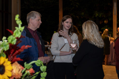 Guests talk to each other inside of the George Washington Presidential Library.