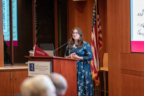 A speaker at the podium at the George Washington Presidential Library.