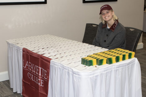Grace Moser smiles at a check in table.