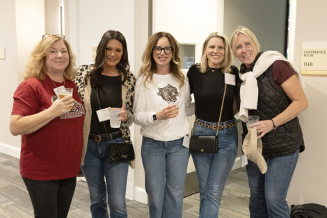A group of alumni smile