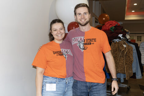 Two alumni wear split Oregon and Lafayette shirts