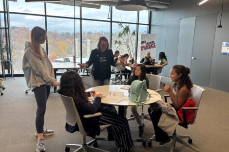 Jenn Rossman and a Lafayette volunteer work with a group of three Girl Scouts in the Dyer Center
