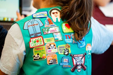 Close up of the badges on a Girl Scout's vest