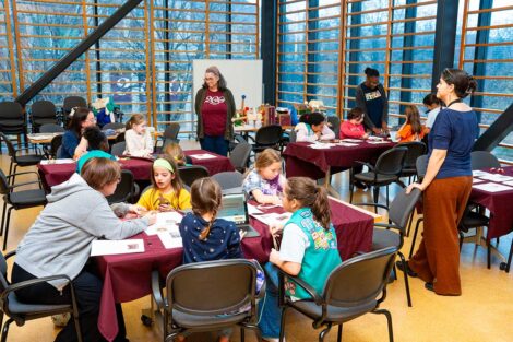 Girl Scouts in Skillman Library's Gendebien Room with Library staff learning about research