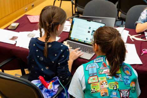 Girl Scouts working together on a laptop in Skillman Library's Gendebien Room