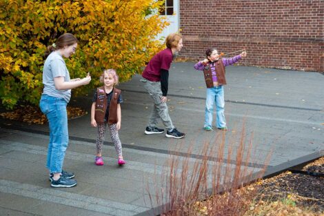 Girl Scouts launching fling airplanes outside of Rockwell Integrated Sciences Center with Lafayette students