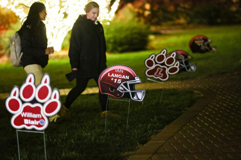 Lawn signs posted with names of football players.